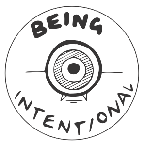 A circular badge illustration of the words Being Intentional set around an archery target.